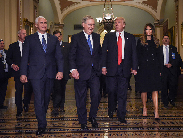 WASHINGTON, DC - NOVEMBER 10: President Elect Donald Trump, center right, walks through the halls of the U.S. Capitol for a meeting with Senate Majority Leader Mitch McConnell, center left, (R-KY) on November, 10, 2016 in Washington, DC. Accompanying him are his wife, Melania, right, and Vice President Elect Mike Pence, left. (Photo by Bill O'Leary/The Washington Post via Getty Images)